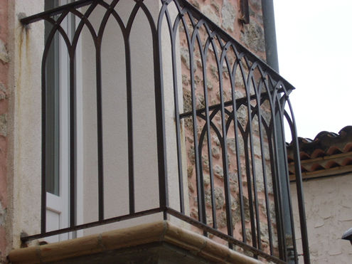 balcony railing with intertwined elements and rivets